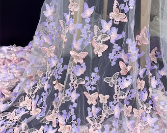 May include: White tulle fabric with embroidered pink and purple butterflies. The butterflies are 3D and have a delicate, feminine look.