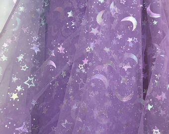 May include: Purple sheer fabric with a repeating pattern of iridescent silver stars and crescent moons.