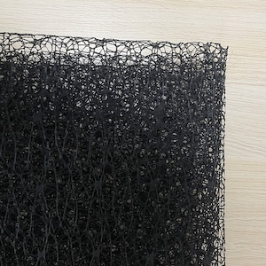 May include: Black netting fabric with a fine, intricate weave. The fabric has a slightly textured surface and a delicate, almost lacy appearance.
