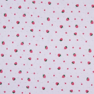 May include: White fabric with a repeating pattern of small pink flowers and red strawberries.