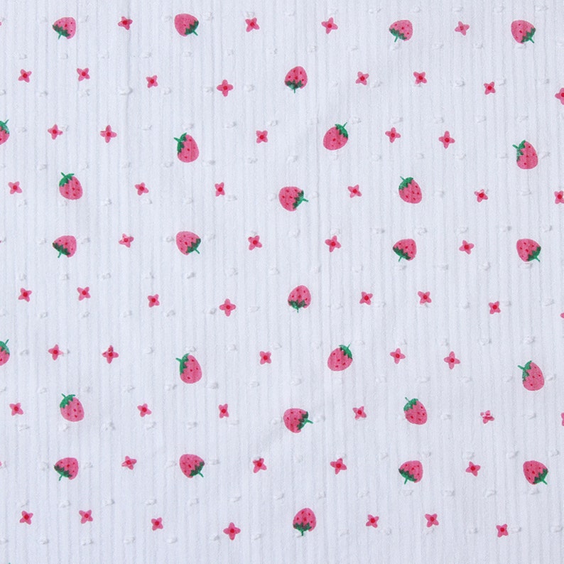 May include: White fabric with a repeating pattern of pink strawberries and small pink flowers.