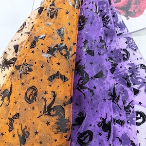 May include: Close-up of Halloween-themed fabric in orange, purple, and light purple. The fabric is patterned with black silhouettes of bats, witches, stars, and pumpkins. The fabric has a glittery, shimmering effect.