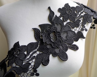 May include: Black floral lace trim with a delicate design featuring intricate flowers and leaves. This trim is perfect for adding a touch of elegance to any project.