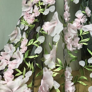 May include: Pink and green floral lace fabric with 3D flowers. The fabric is sheer and has a delicate texture.