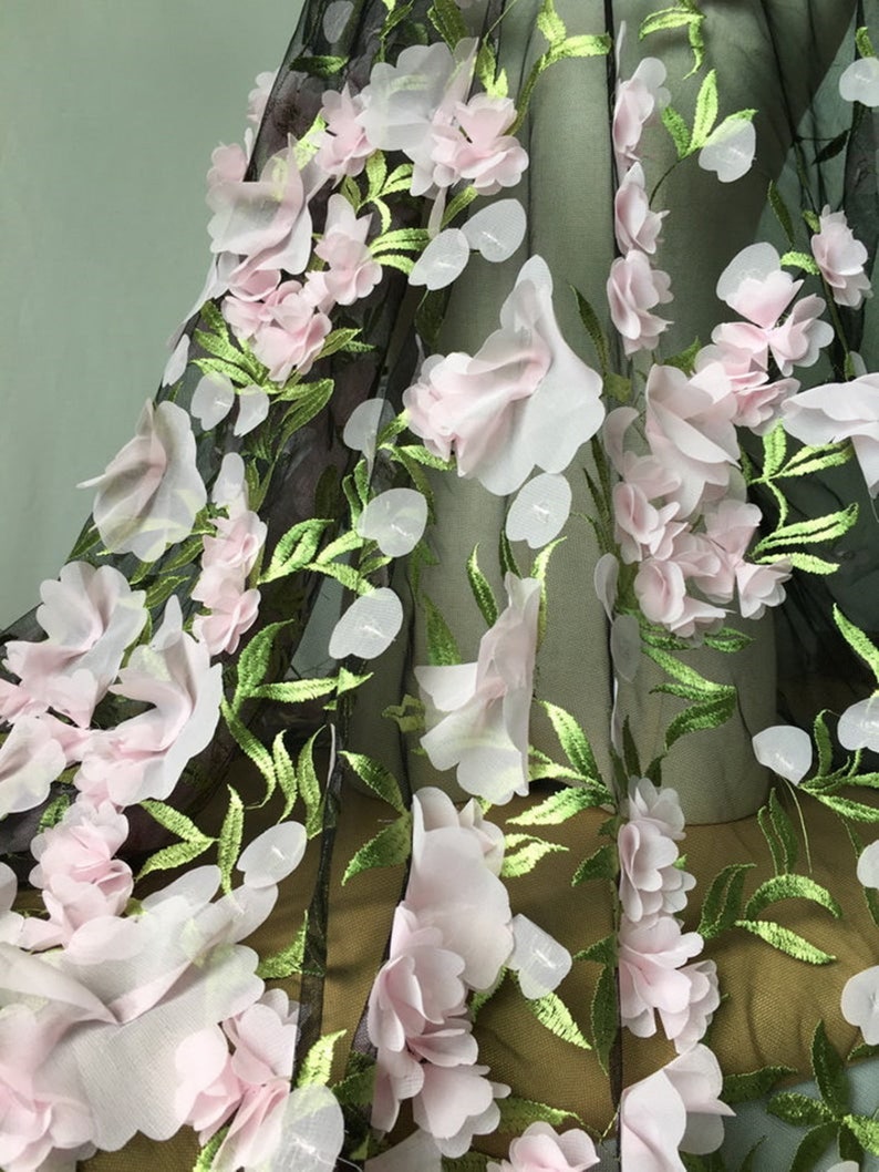 May include: Pink and green floral lace fabric with 3D flowers. The fabric is sheer and has a delicate texture.