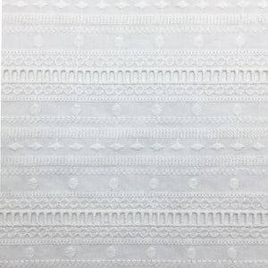 May include: White cotton fabric with an embroidered pattern of circles, diamonds, and scalloped edges.