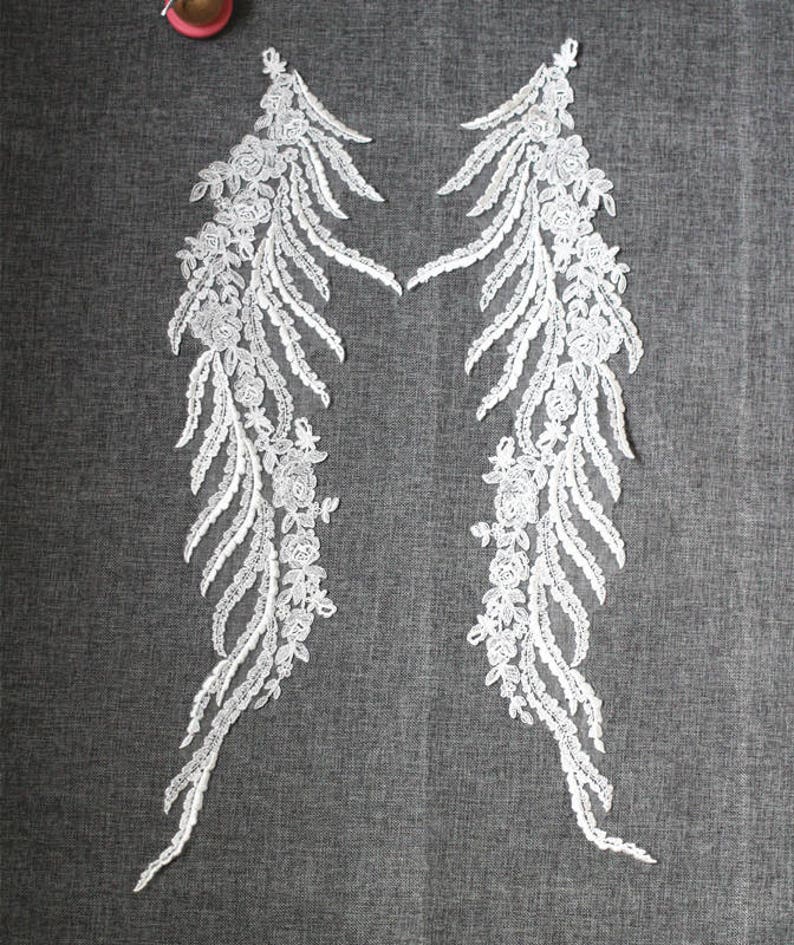 Wings Design Embroider and heavy beading on a mesh lace-sold by the yard. Off White