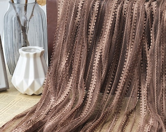 May include: Brown striped fabric with a textured, beaded design. The fabric is sheer and has a delicate, feminine feel.