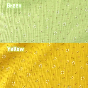 May include: Close-up of two sections of fabric. The top section is light green with small white and red floral patterns. The bottom section is yellow with similar floral patterns. The word "Green" is written in white on the top section, and "Yellow" on the bottom.