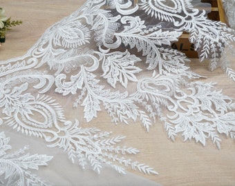 May include: White lace trim with a floral design. The lace is delicate and intricate, with a scalloped edge.
