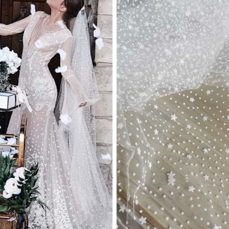 May include: White tulle fabric with small white polka dots and larger white star shapes.