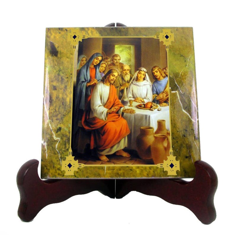 May include: A ceramic tile with a green marble background and a gold frame. The tile features a painting of Jesus and his disciples at the Last Supper. The painting is in a realistic style and depicts the scene in a warm, inviting setting.