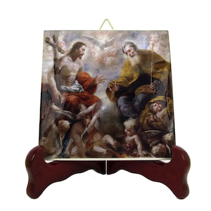 May include: A ceramic tile with a religious painting of Jesus and God the Father. The painting is set against a cloudy sky with a dove flying above. The tile is mounted on a wooden stand.