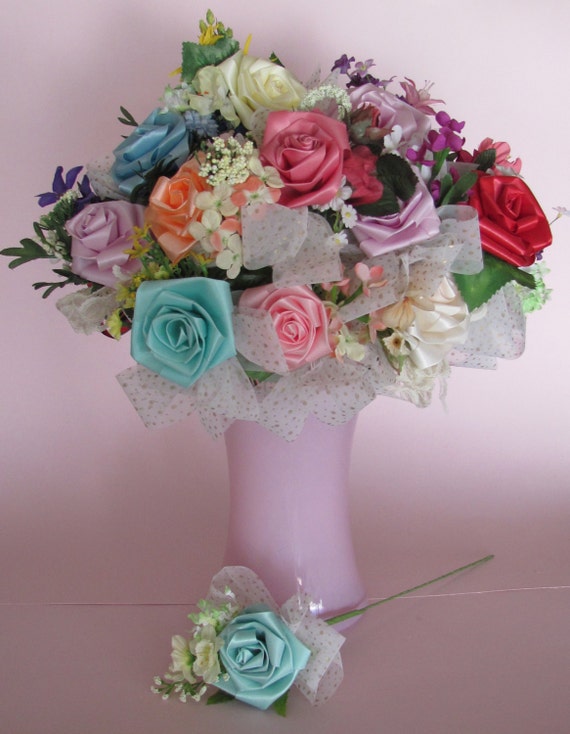 Hand made ribbon roses in 10 beautiful colors, each with spray of assorted, complimentary silk flowers and bow. No two are ever quite alike.