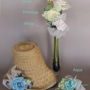 May include: A straw hat with a sky blue satin flower and a bouquet of ivory, white, and primrose silk flowers in a green vase with aqua blue satin flower.