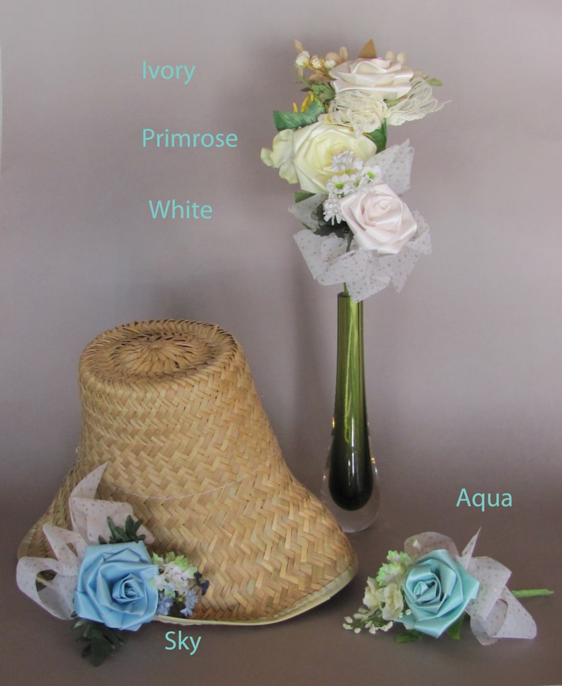 May include: A straw hat with a sky blue satin flower and a bouquet of ivory, white, and primrose silk flowers in a green vase with aqua blue satin flower.