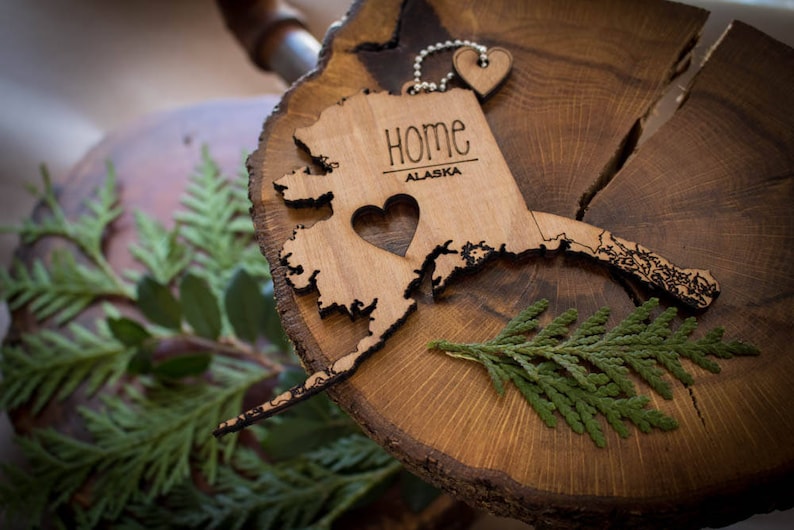 All US State Ornaments. Heart & Home. Show love for the place that stole your heart with these Ornaments, Keychains, and tokens of love Alaska