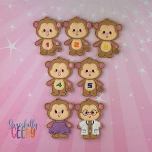 May include: A collection of seven felt monkey appliqués. Six monkeys have numbers 1-5 and one with a doctor's coat and stethoscope. One monkey wears a purple dress. The text "Gracefully Geeky" is in the lower left corner.