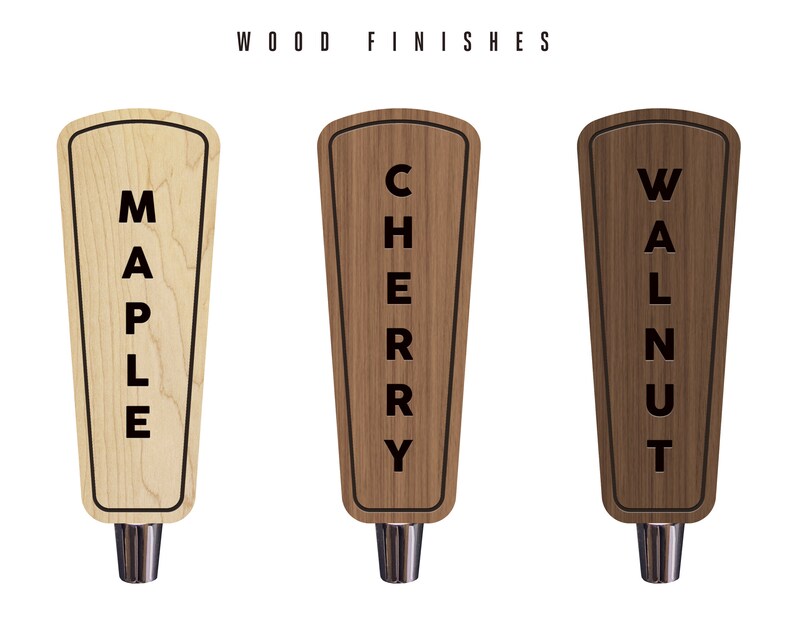 May include: Three wooden beer tap handles with different wood finishes: maple, cherry, and walnut. Each handle has the wood type written vertically on the front.