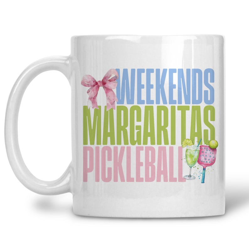 May include: White ceramic mug with the words "WEEKENDS MARGARITAS PICKLEBALL" in blue, green, and pink. A watercolor bow and illustrations of a margarita and pickleball paddle are also featured.