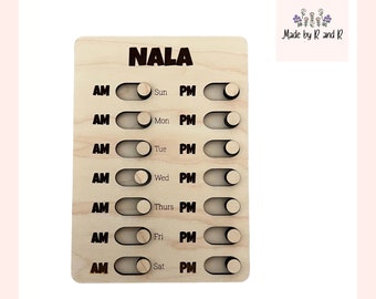 May include: A wooden personalized daily schedule board with the name "NALA" at the top. The board has seven rows, each with a day of the week, "Sun" through "Sat", and two columns, "AM" and "PM". Each row has a toggle switch to indicate whether the activity is in the morning or afternoon.