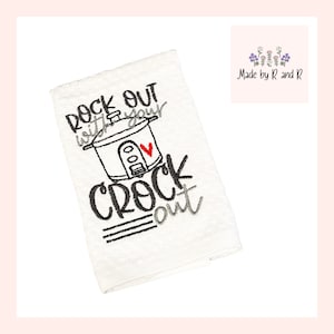 May include: White kitchen towel with black embroidery that reads "Rock out with your crock out". The embroidery includes a stylized image of a slow cooker with a red heart.