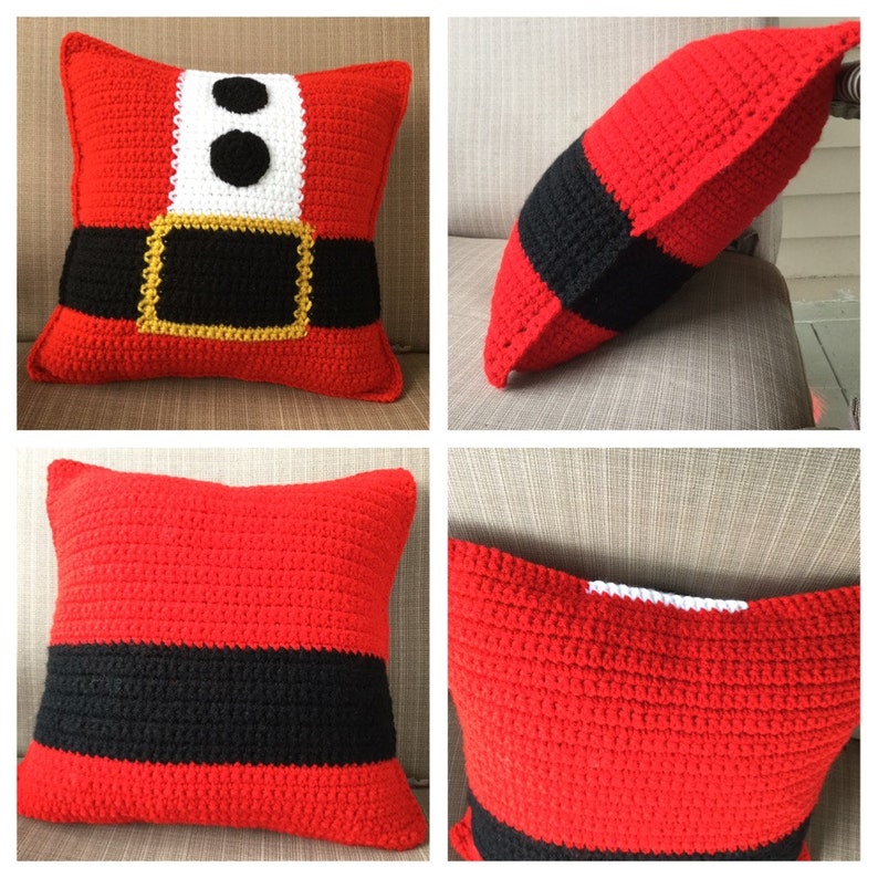 May include: A red, black, and white crocheted pillow with a Santa Claus suit design. The pillow is square and has a white trim around the edges.
