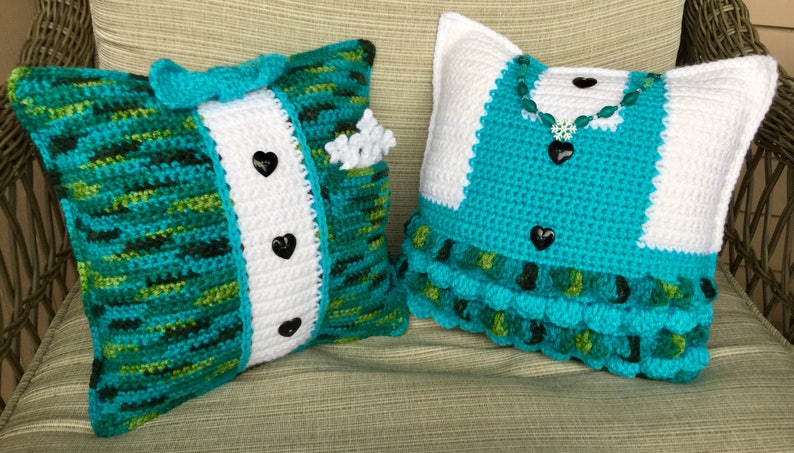 May include: Two crocheted pillows, one with a tuxedo design in green, white, and black, and the other with a dress design in turquoise, white, and green.