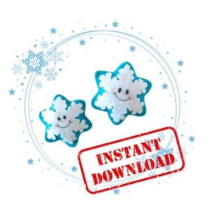 May include: Two blue and white felt snowflake ornaments with smiling faces. The ornaments are on a white background with a blue circle and snowflakes around them. The text "INSTANT DOWNLOAD" is in a red stamp.