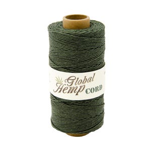 May include: A spool of dark green hemp cord with a label that reads "Global Hemp Cord".
