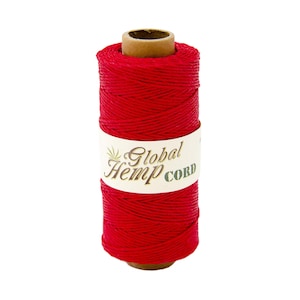 May include: A spool of red hemp cord with the label "Global Hemp Cord" on it.