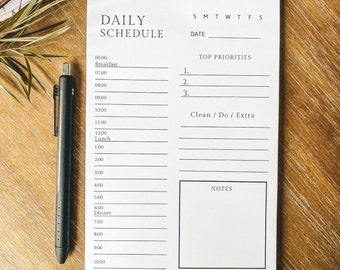 May include: A printable daily schedule planner with sections for top priorities, clean/do/extra, and notes. The planner includes a time slot column from 6:00 AM to 10:00 PM.
