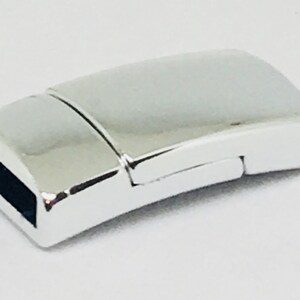 May include: Silver-toned magnetic clasp for jewelry making. The clasp is rectangular and has a smooth, polished finish.