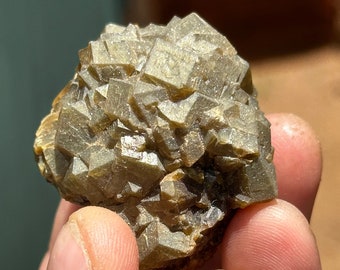 Iridescent green andradite rainbow garnet cluster , Stanley butte ,Arizona.