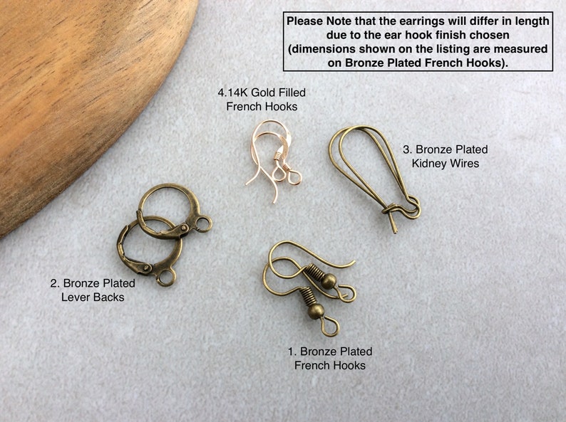 May include: An assortment of earring findings, including bronze-plated lever backs, French hooks, and kidney wires. The image also shows 4.14K gold-filled French hooks. Text on the image states that earring length will vary.