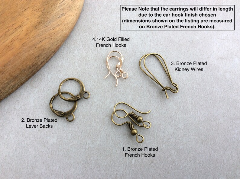 May include: An assortment of earring findings, including bronze-plated lever backs, French hooks, and kidney wires. The image also shows 4.14K gold-filled French hooks. Text on the image states that earring length will vary.