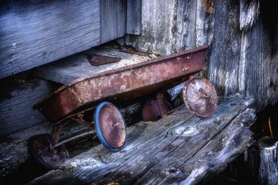 Left and Forgotton (Metal Panel) a vintage little red wagon left at a bunkhouse on the ranch