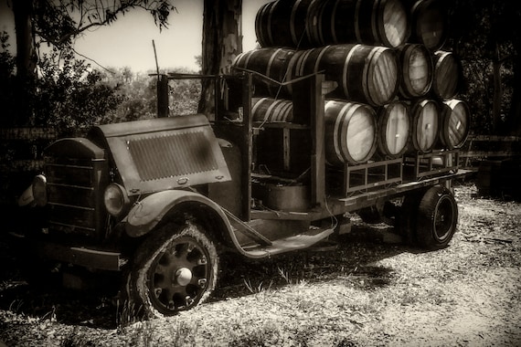 Haulin it (Metal Panel) an old wine truck loaded with barrels of wine black and white digital photograph
