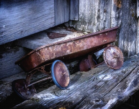 Left and Forgotten (Prints) an antique little red wagon left at a bunkhouse