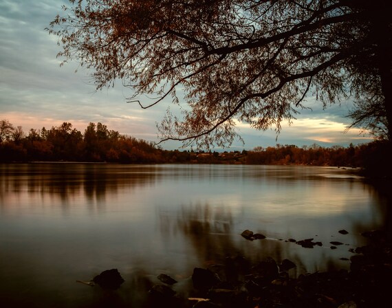 Subdued (prints) long exposure photograph sunset Sacramento River California reflections on the water