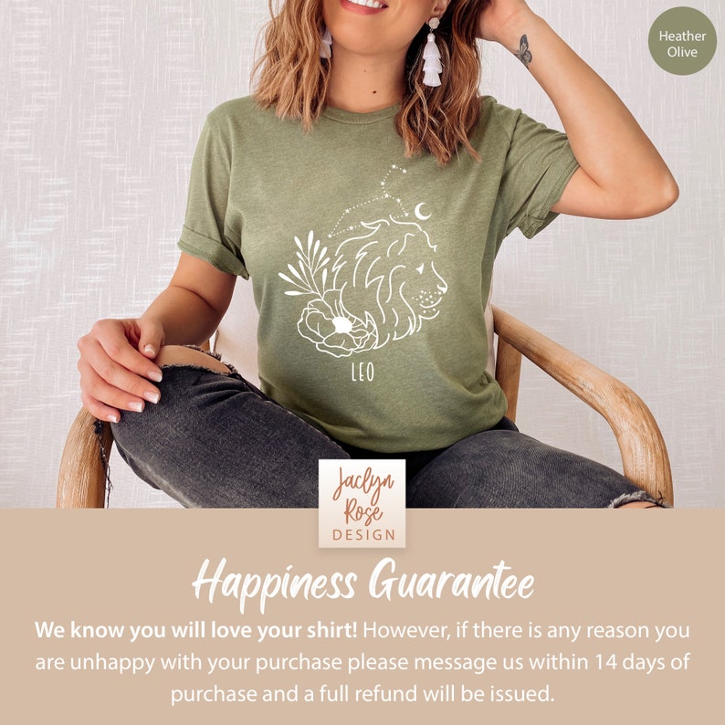 May include: Green t-shirt with a white outline of a lion, flowers, and stars. The text "LEO" is below the lion. The shirt is on a person sitting in a chair. The text "Happiness Guarantee" is at the bottom of the image.