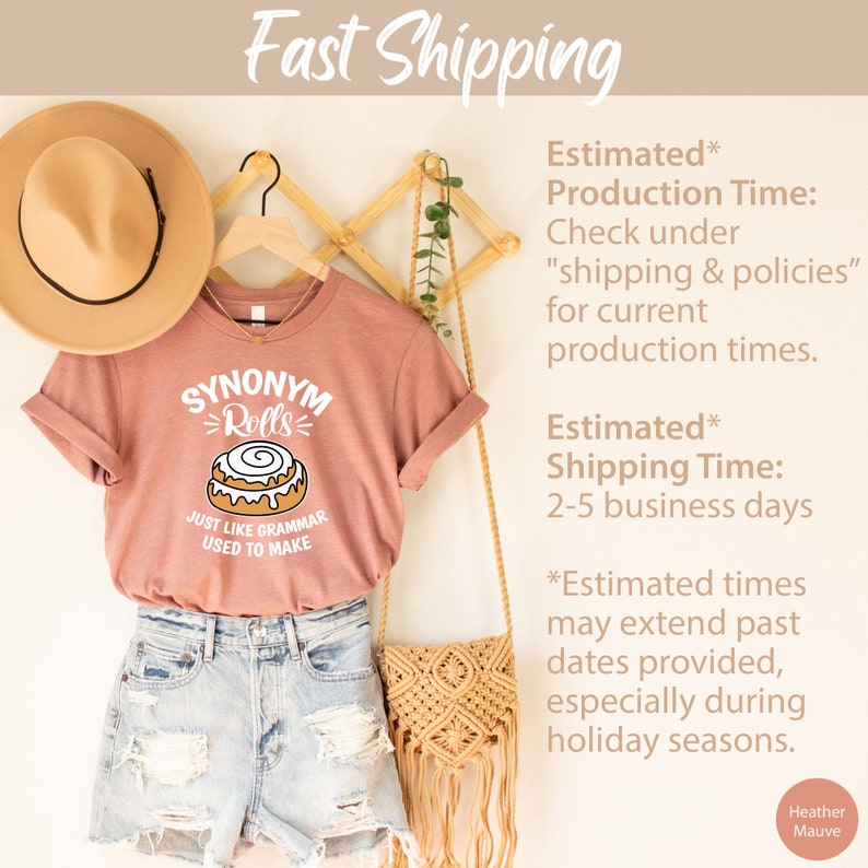 May include: A heather mauve t-shirt with a white graphic of a cinnamon roll and the text "Synonym Rolls" and "Just like grammar used to make".