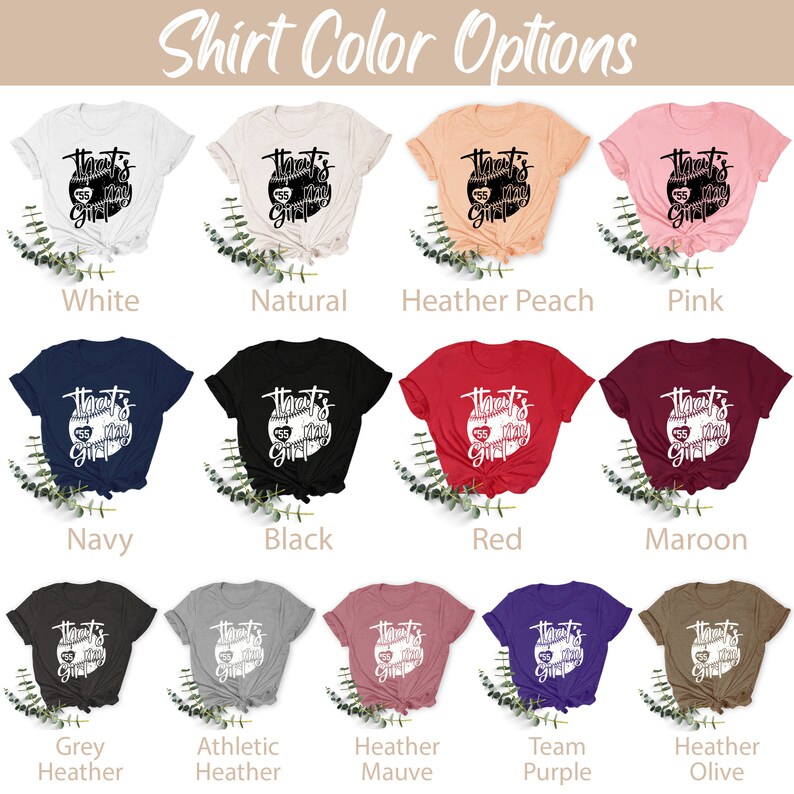 May include: A graphic t-shirt design featuring a baseball with the text "That's my girl" in white. The shirt is shown in 14 different colors, including white, natural, heather peach, pink, navy, black, red, maroon, grey heather, athletic heather, heather mauve, team purple, and heather olive.