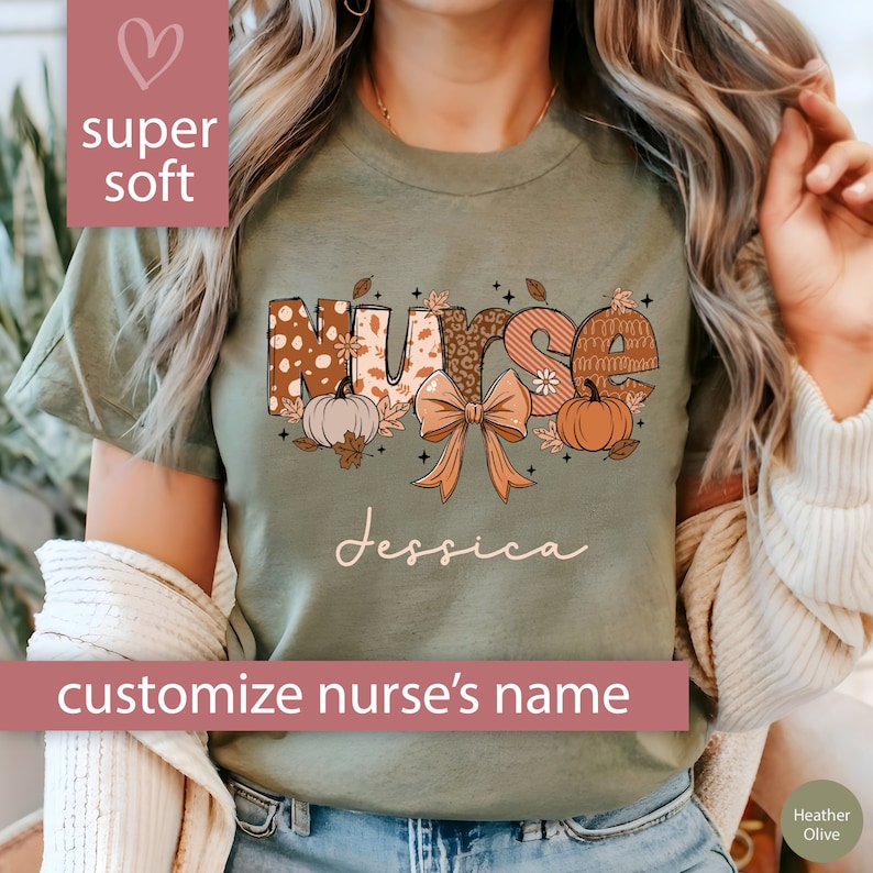 May include: A green t-shirt with the word "Nurse" in fall-themed patterned letters. The letters are decorated with pumpkins, leaves, and a bow. The text "Jessica" is printed below the word "Nurse".