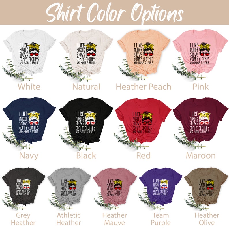 May include: A graphic t-shirt design featuring a woman with sunglasses and a bun, with the text "I like murder shows comfy clothes and maybe 3 people". The shirt is available in 12 different colors: white, natural, heather peach, pink, navy, black, red, maroon, grey heather, athletic heather, heather mauve, team purple, and heather olive.