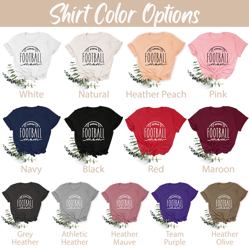 May include: A selection of t-shirts in various colors, each featuring a white graphic of a football with the text "FOOTBALL mom". The colors include white, natural, heather peach, pink, navy, black, red, maroon, grey heather, athletic heather, heather mauve, team purple, and heather olive.
