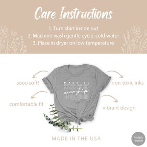 May include: Gray t-shirt with the text "MADE TO WORSHIP" printed in white. The shirt is made in the USA and features a comfortable fit, soft fabric, and non-toxic inks.