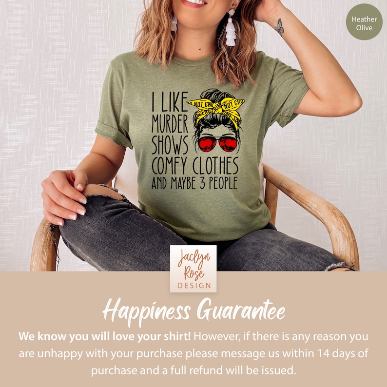 May include: A green t-shirt with the text "I like murder shows, comfy clothes and maybe 3 people". The text is in black and there is a graphic of a woman with a messy bun, sunglasses, and a yellow ribbon in her hair. The ribbon has the text "NOT CRAZY NOT CHOO" on it.