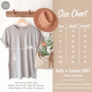 May include: A size chart for a unisex jersey tee, showing measurements in inches for width and length. The chart includes sizes XS through 3XL. The text "Bella + Canvas 3001" is also included.