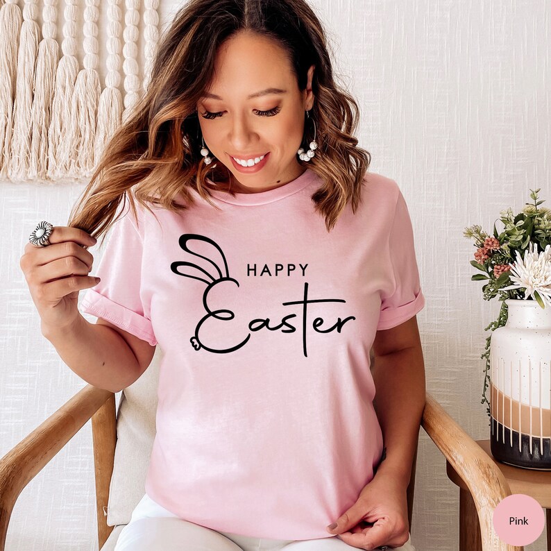May include: A pink t-shirt with a black graphic of a bunny rabbit and the text "Happy Easter".